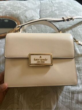 kate spade cream leather top-handle satchel with gold plaque